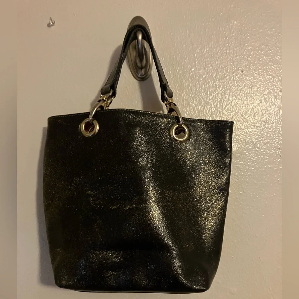 Cute , fun , gold shimmer trimmed n gold and red handbag made in Italy.